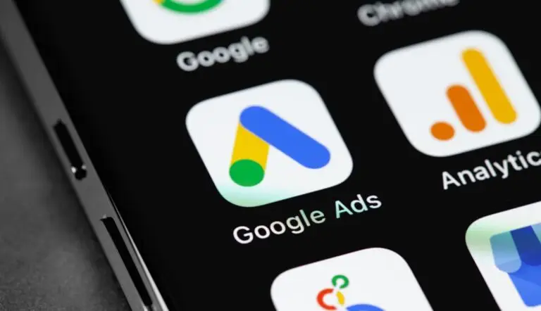 Google Ads app icon on a smartphone screen among other Google service icons, with a focus on the distinctive Google Ads symbol against a dark background, indicating its importance for digital advertising campaign