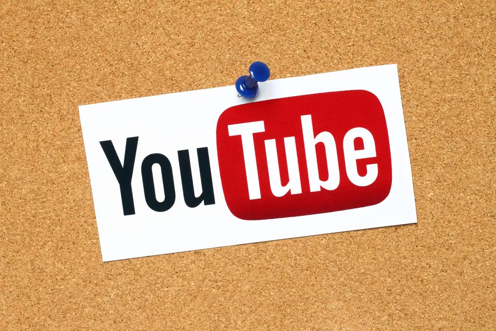 a youtube logo pinned against a corkboard
