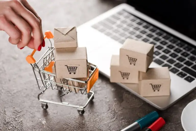 mini shopping cart with boxes on laptop symbolizing e-commerce unit economics management